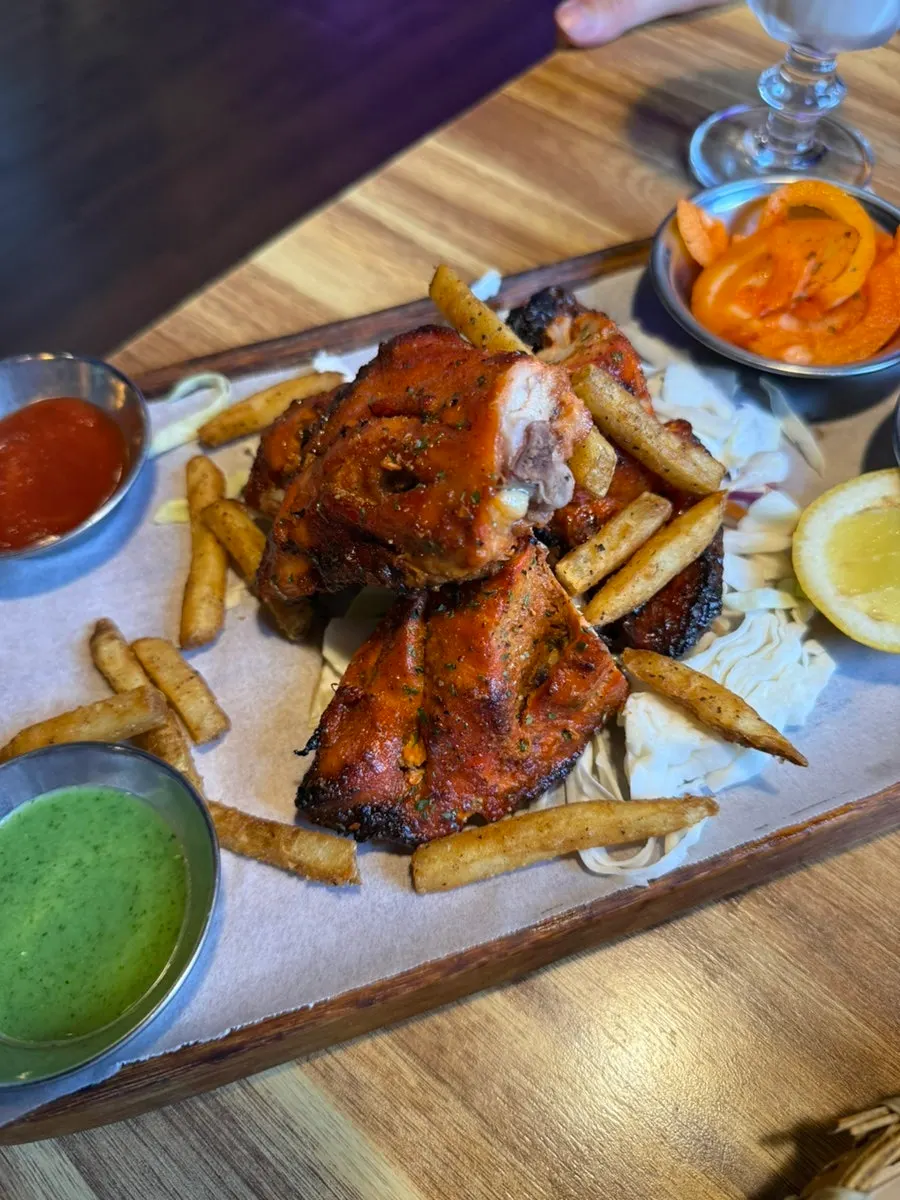 Half tandoori chicken with pickled onion and cabbage salad