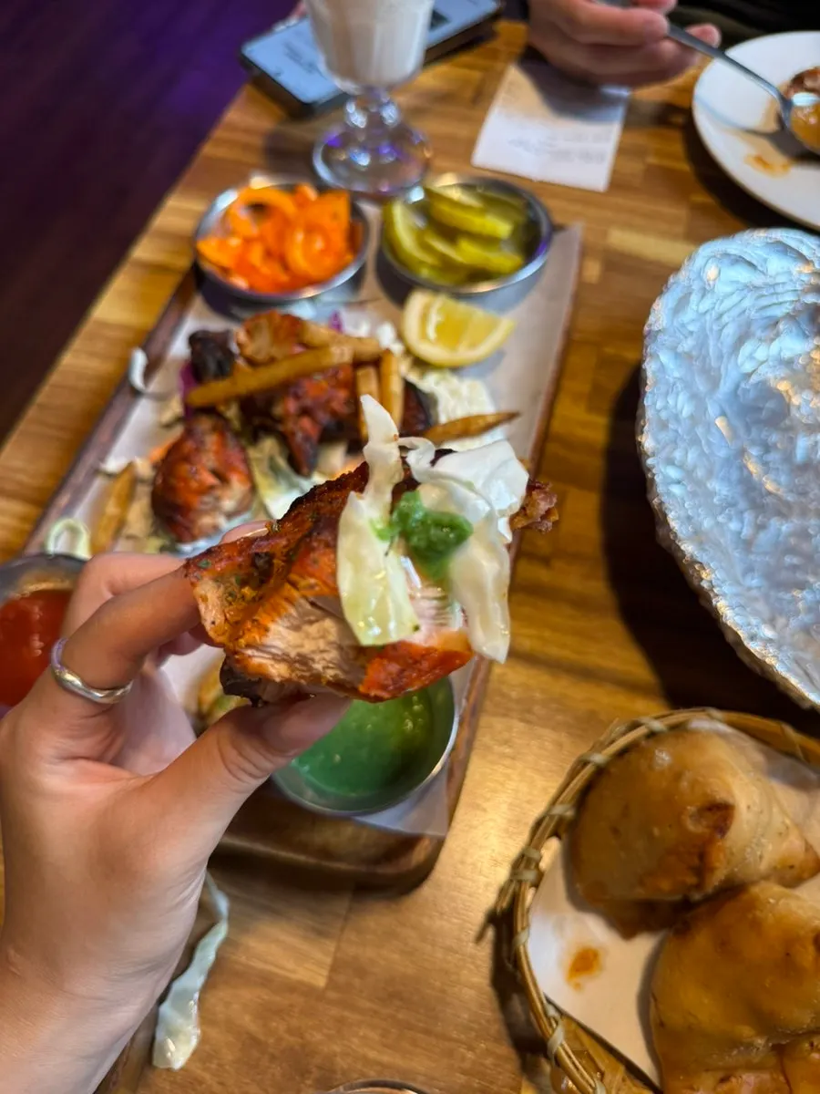 Tandoori chicken breast topped with cabbage salad and sauce