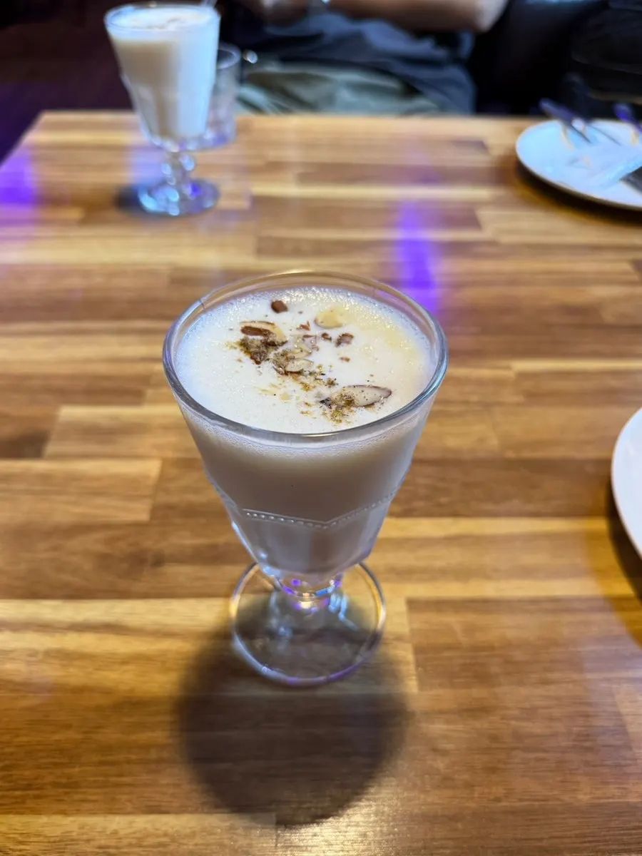 Plain lassi topped with nuts
