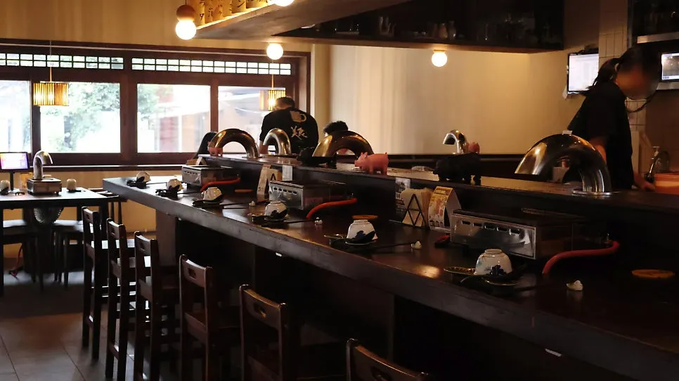 First-floor dining room with counter seating and tables for four