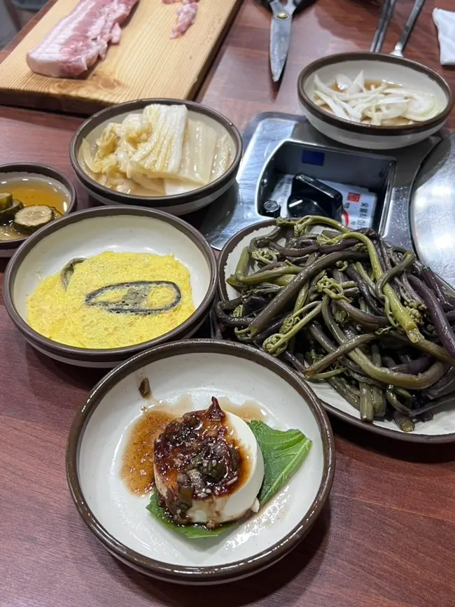 Table set with lettuce wraps, garlic, and ssamjang