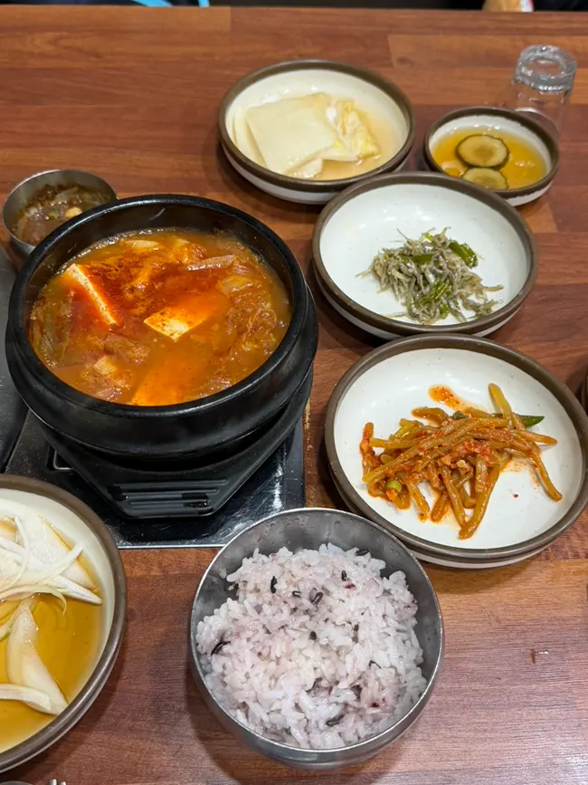 Pork belly kimchi jjigae served bubbling in an earthenware pot