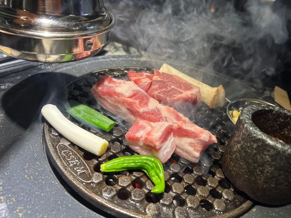 Pork cooking on the charcoal brazier