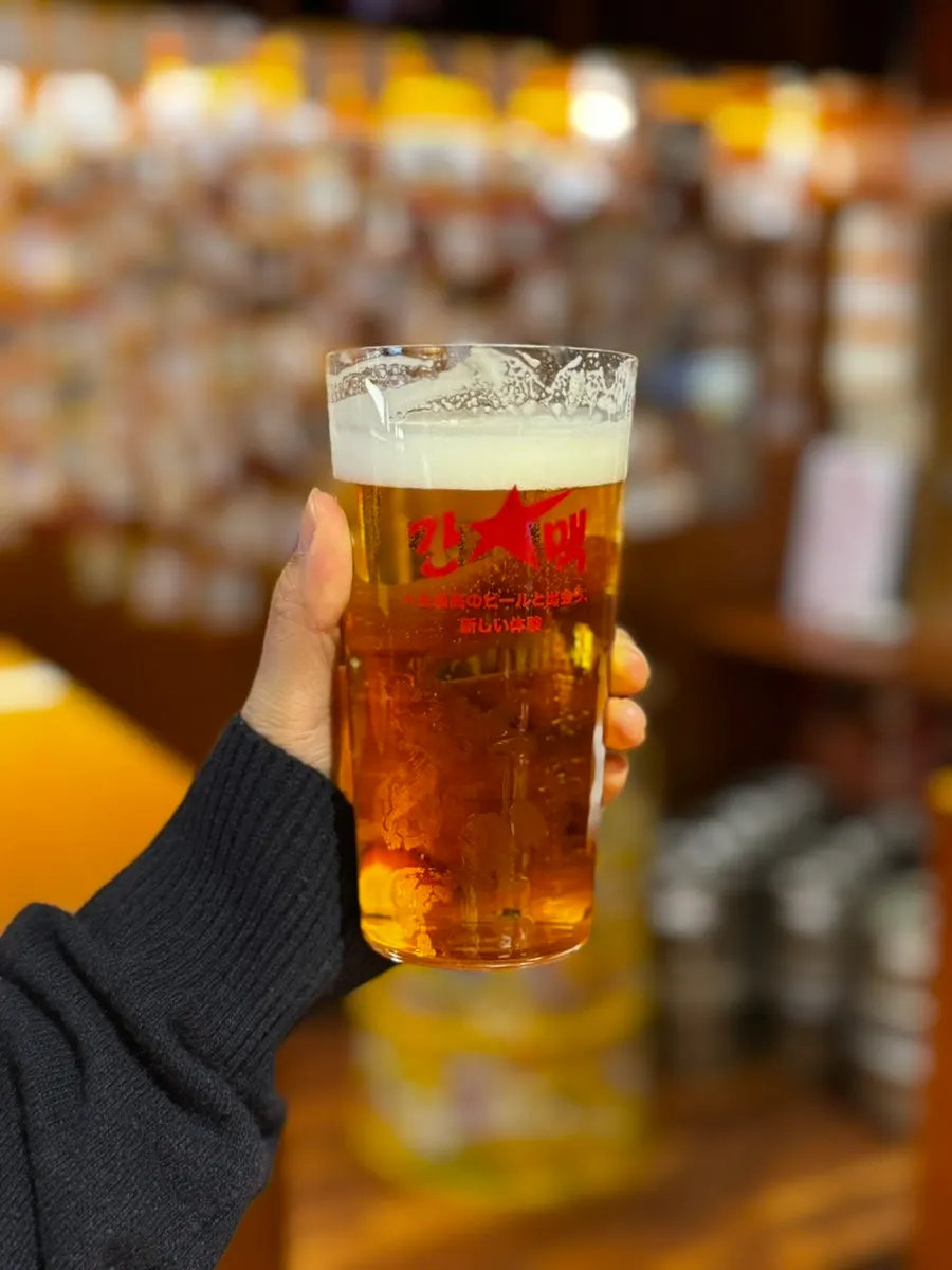 Sapporo draft beer glass with a full foam head
