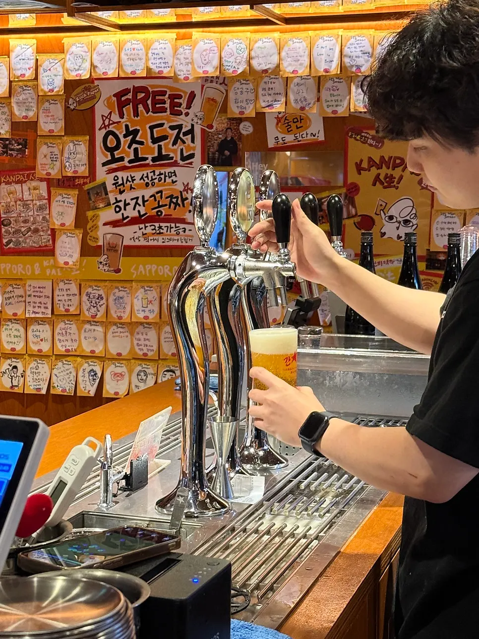 Glass of Ebisu draft beer half finished
