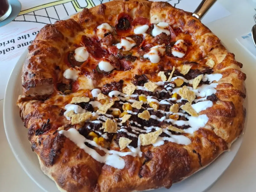 Half-and-half pizza with Hot Honey and Birria Taco flavors