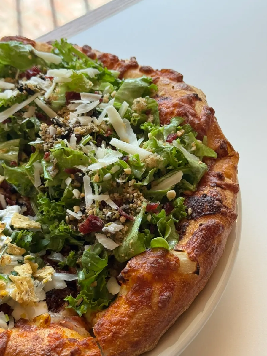 Salad pizza topped with European greens