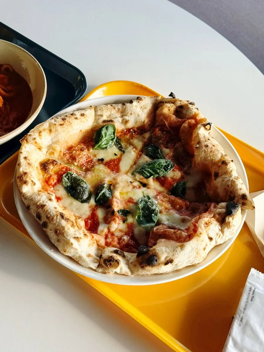 Margherita pizza topped with tomato, cheese, and basil