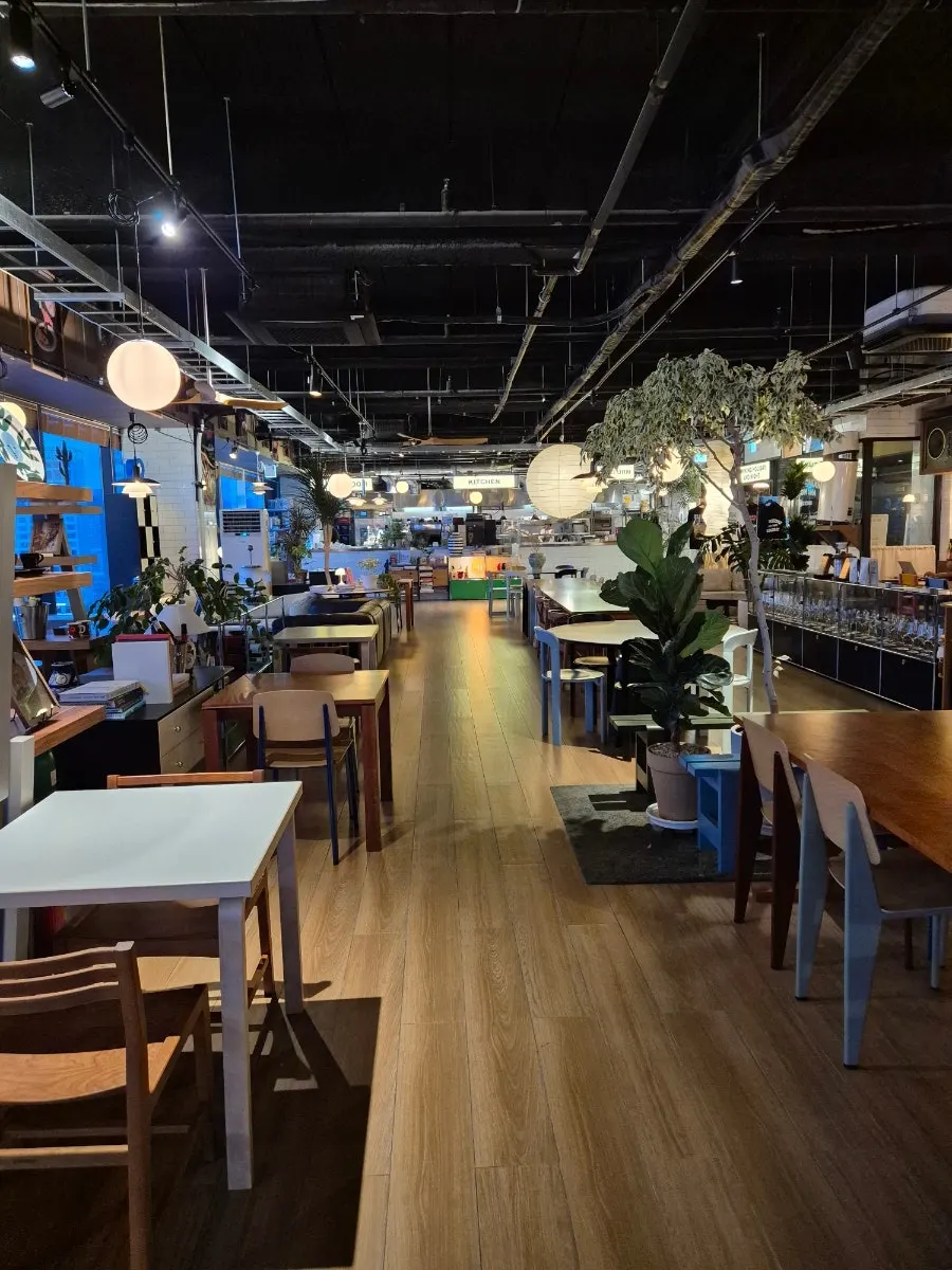 Spacious interior of Working Holiday Minrak with many tables