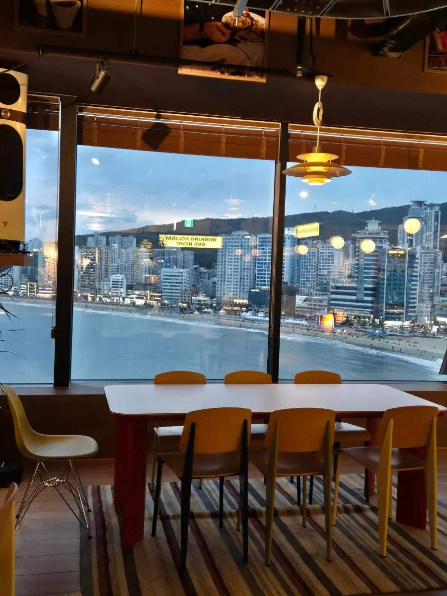 Window seat with a view of Gwangalli beach through the floor-to-ceiling glass