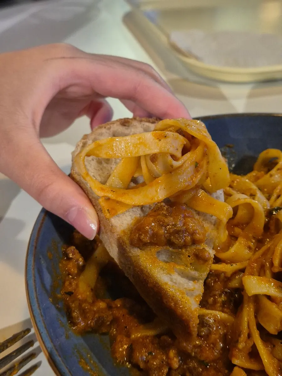 Bolognese pasta noodles lifted with a fork