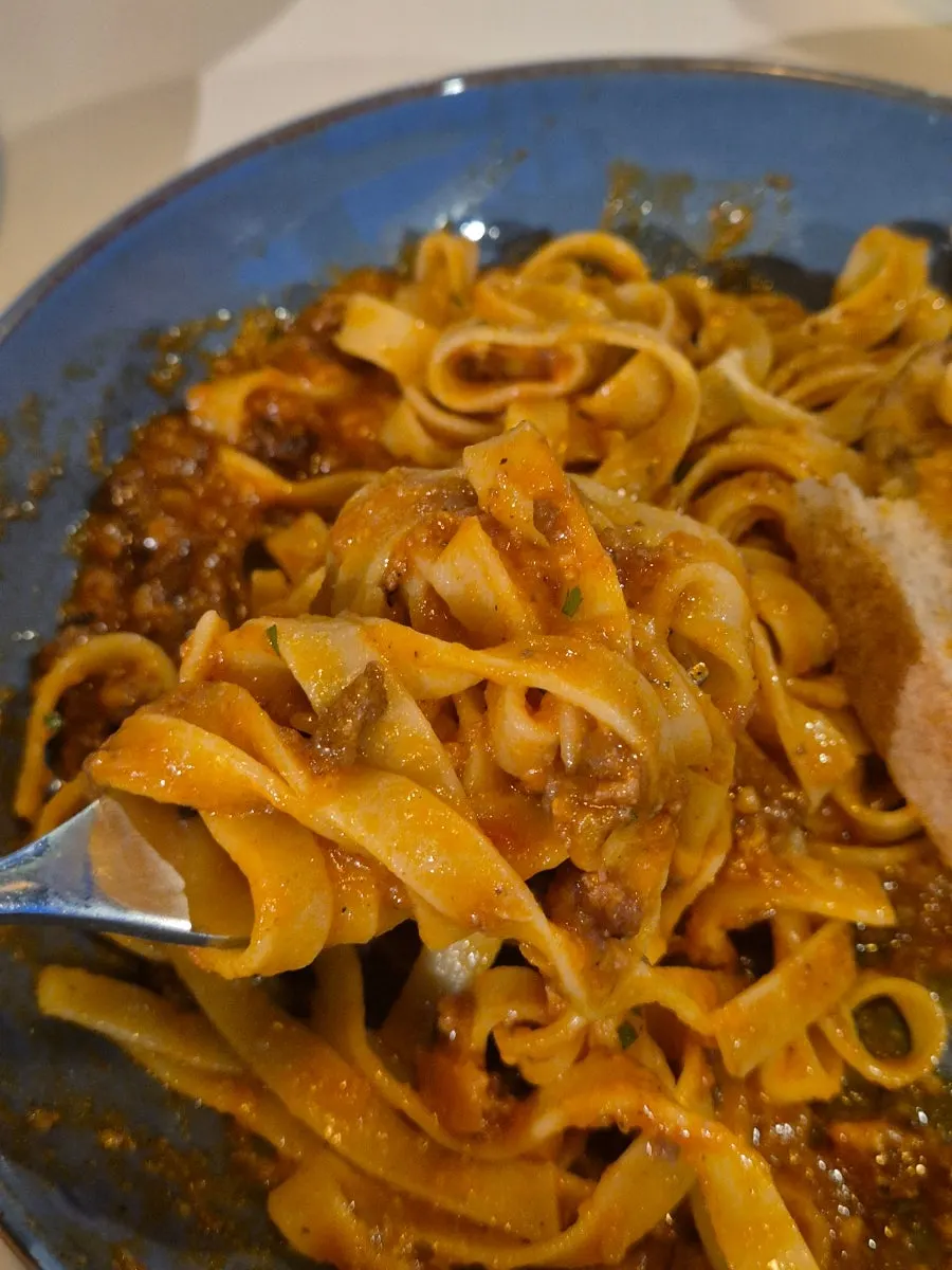 A baguette topped with pasta sauce