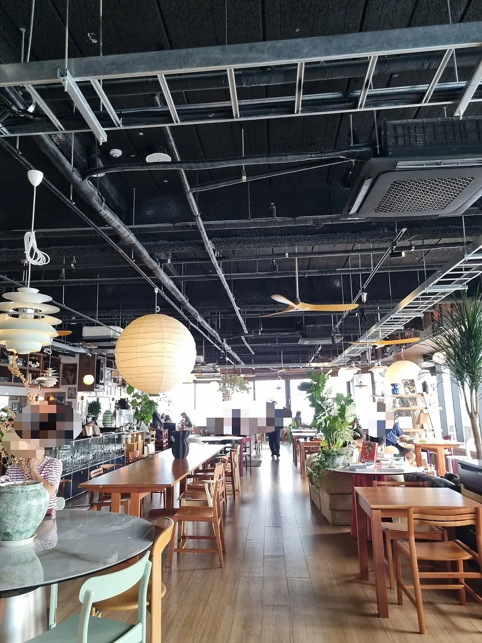 Café interior with high ceiling and large lighting fixture