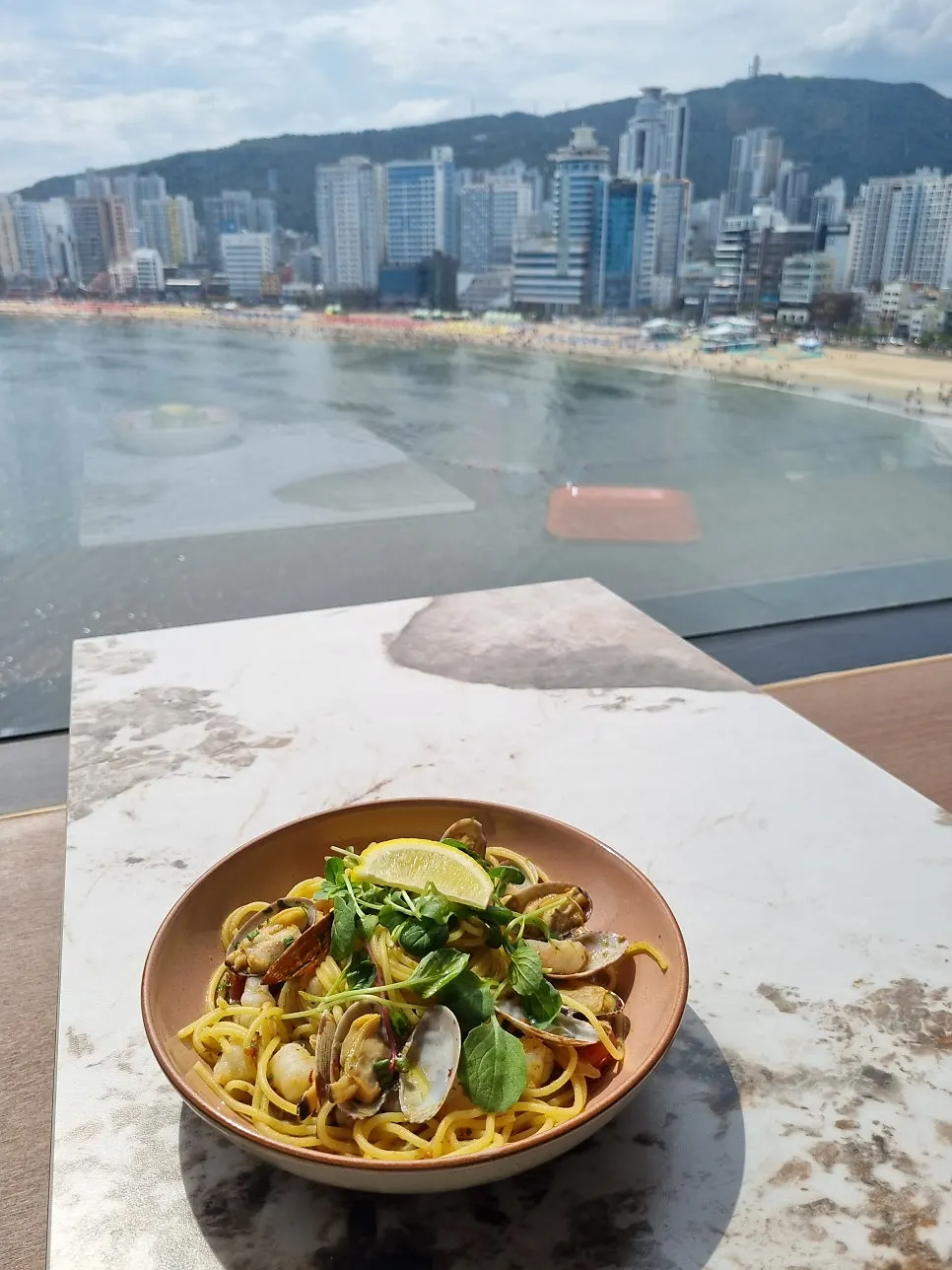 Pizza and pasta set against the ocean backdrop