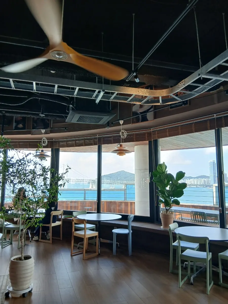 Seating area with 2-top tables and sofa seats by the window