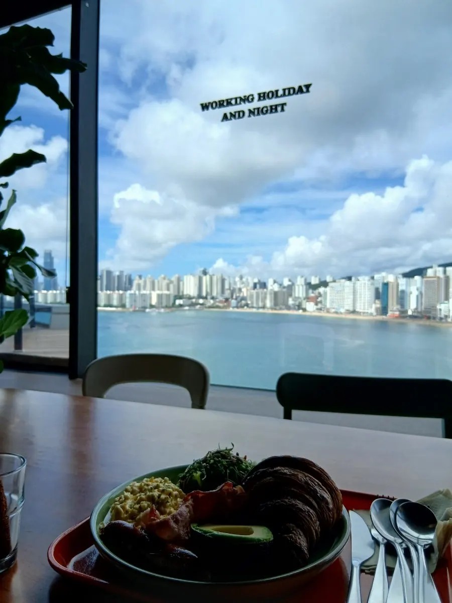 A café table with Gwangalli's sea in the background