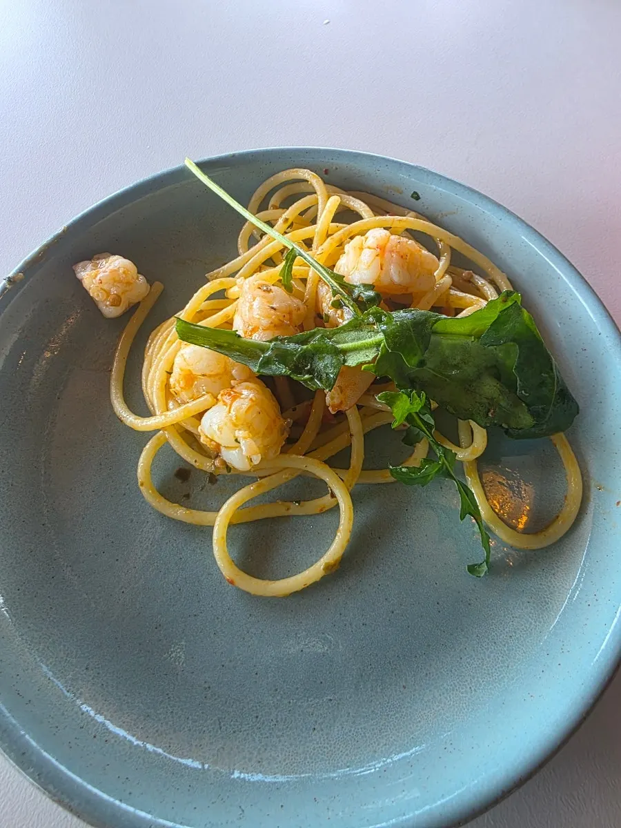 Shrimp oil pasta noodles twirled on a fork