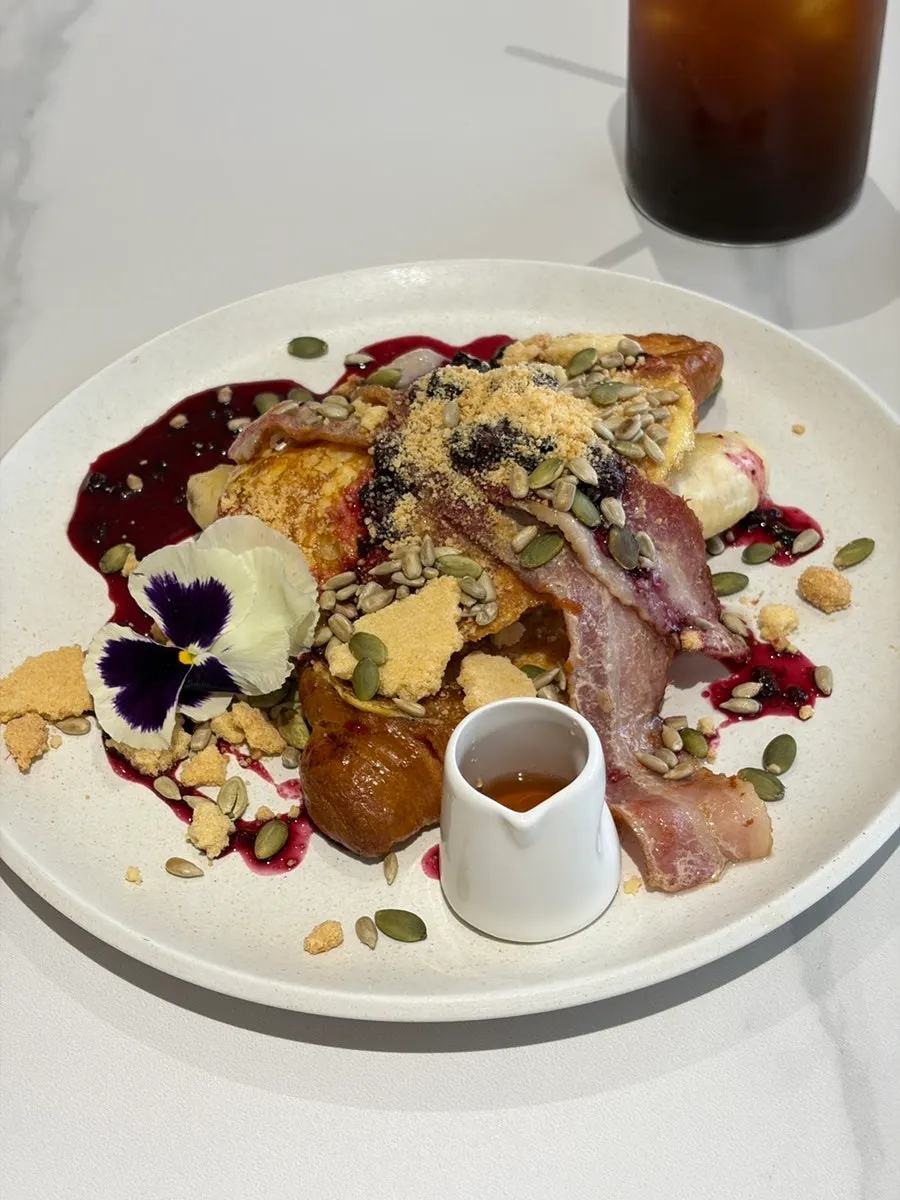 French toast topped with berries and seeds