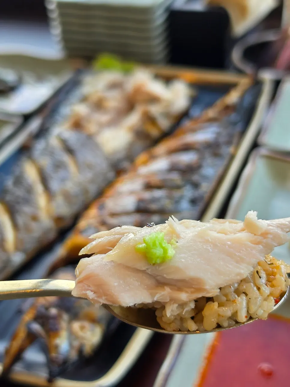 Two pieces of wood-fired grilled Spanish mackerel on a plate