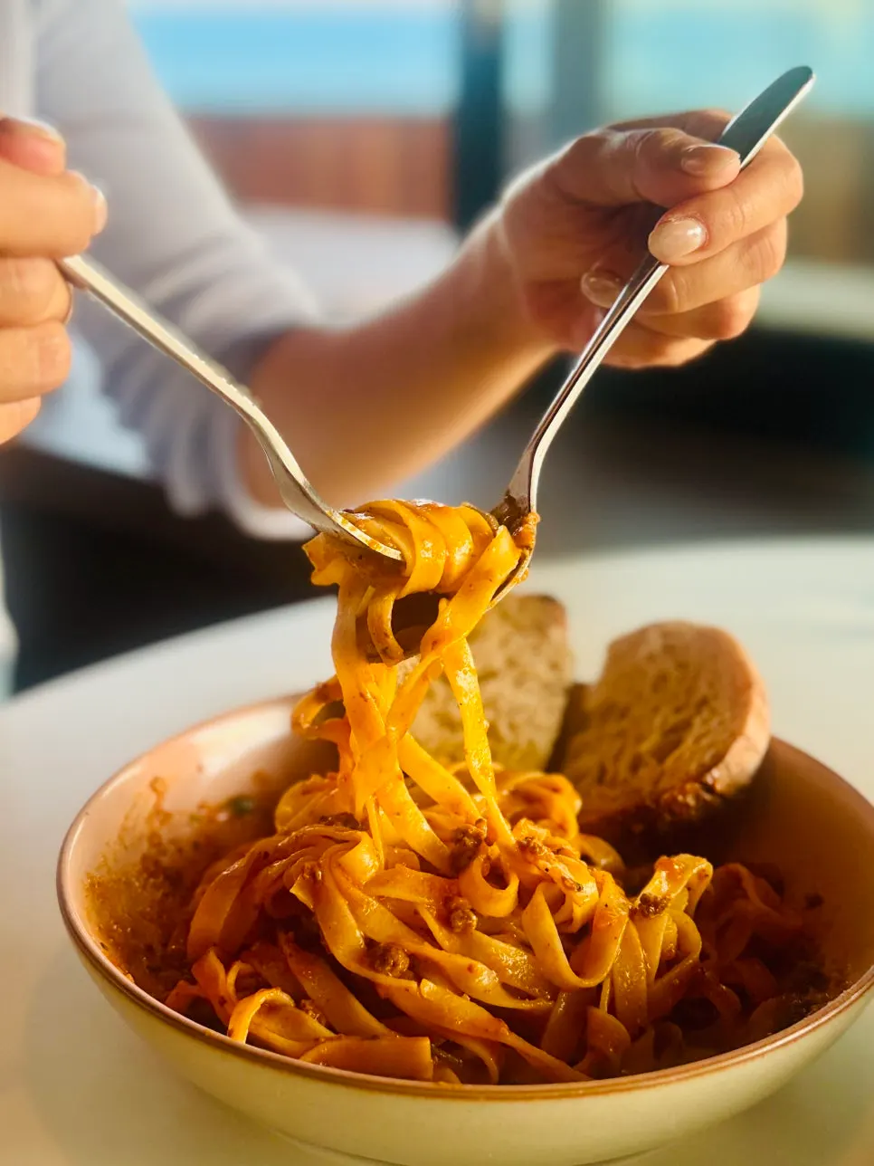 Fork lifting noodles from the Bolognese pasta