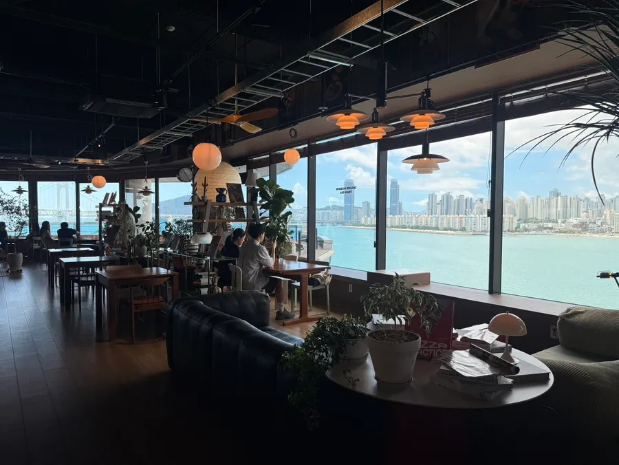 Café interior seating with a view of Gwangalli sea