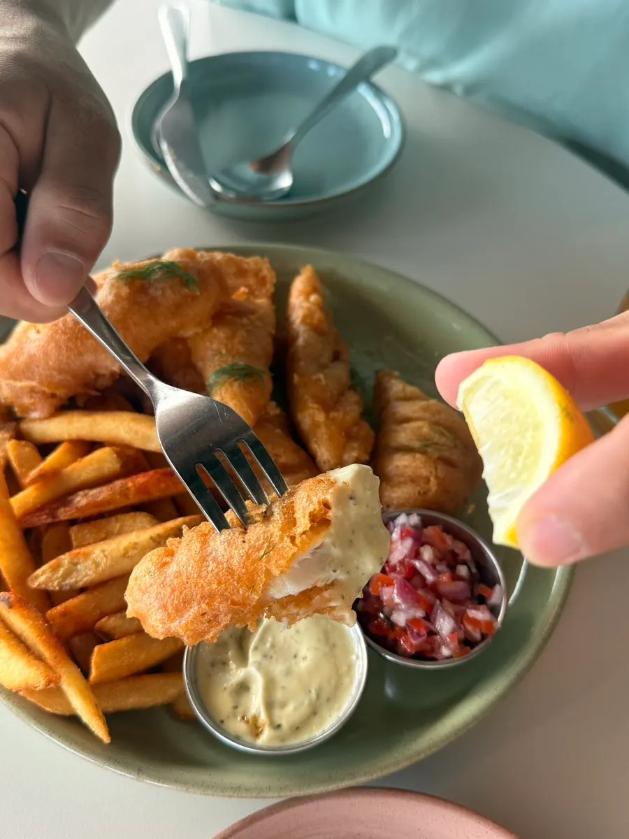 A plate of fish and chips with crispy batter