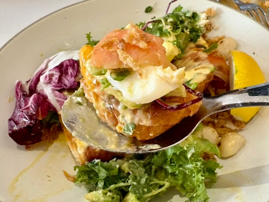 Croissant brunch with poached egg, avocado, and salmon