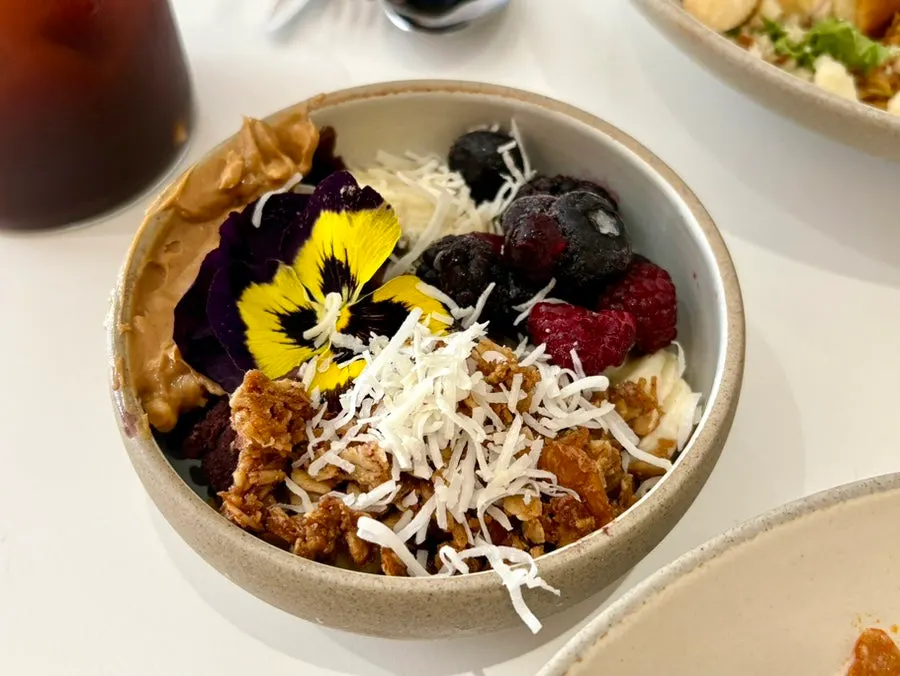 Acai bowl with banana, berries, granola, and peanut butter