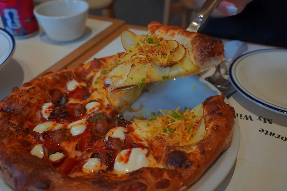 Slice of potato pizza with truffle oil aroma