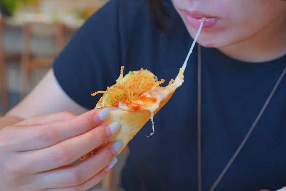 Slice of potato pizza being lifted up