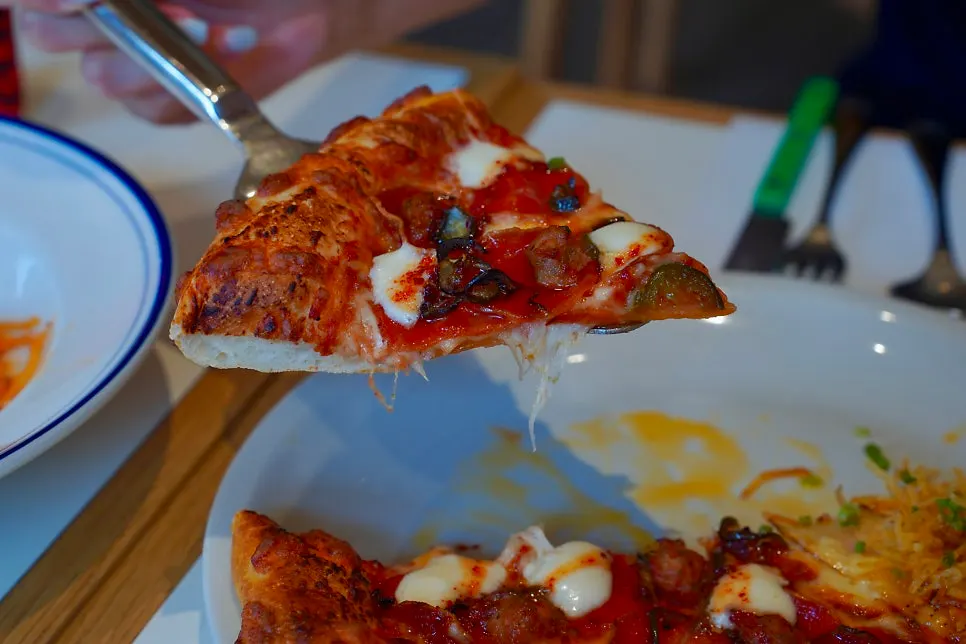 Half of the pizza covered densely with pepperoni