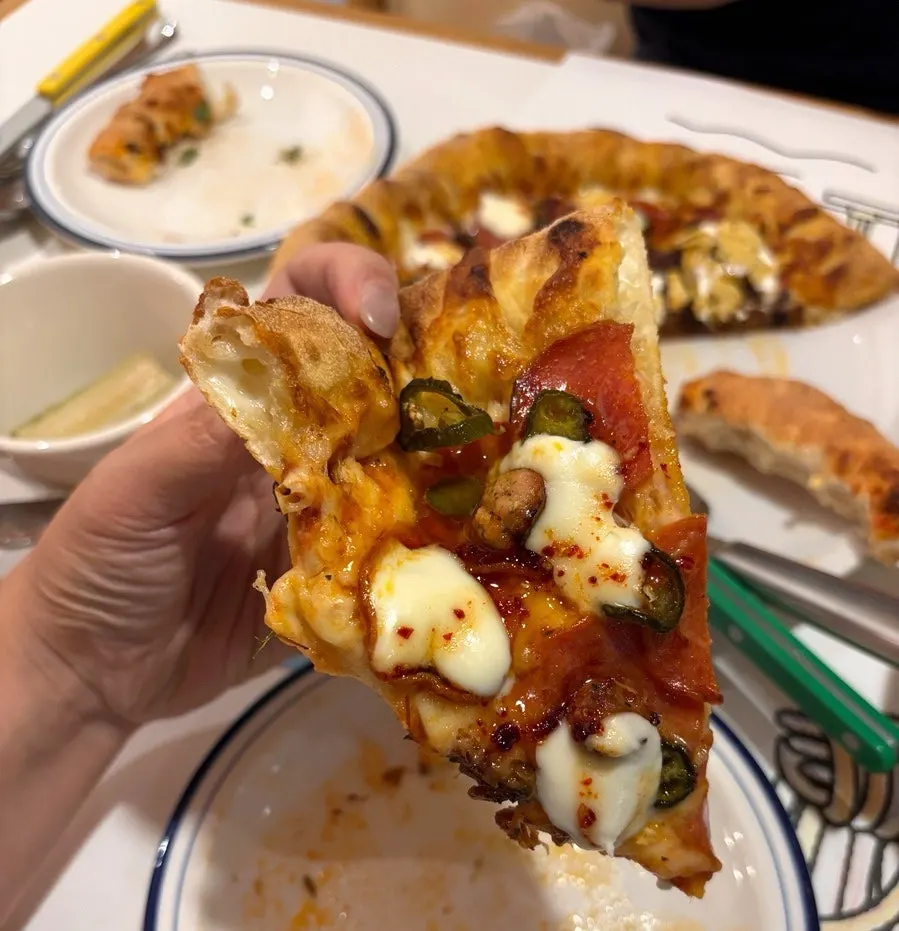 A slice of hot honey pepperoni pizza
