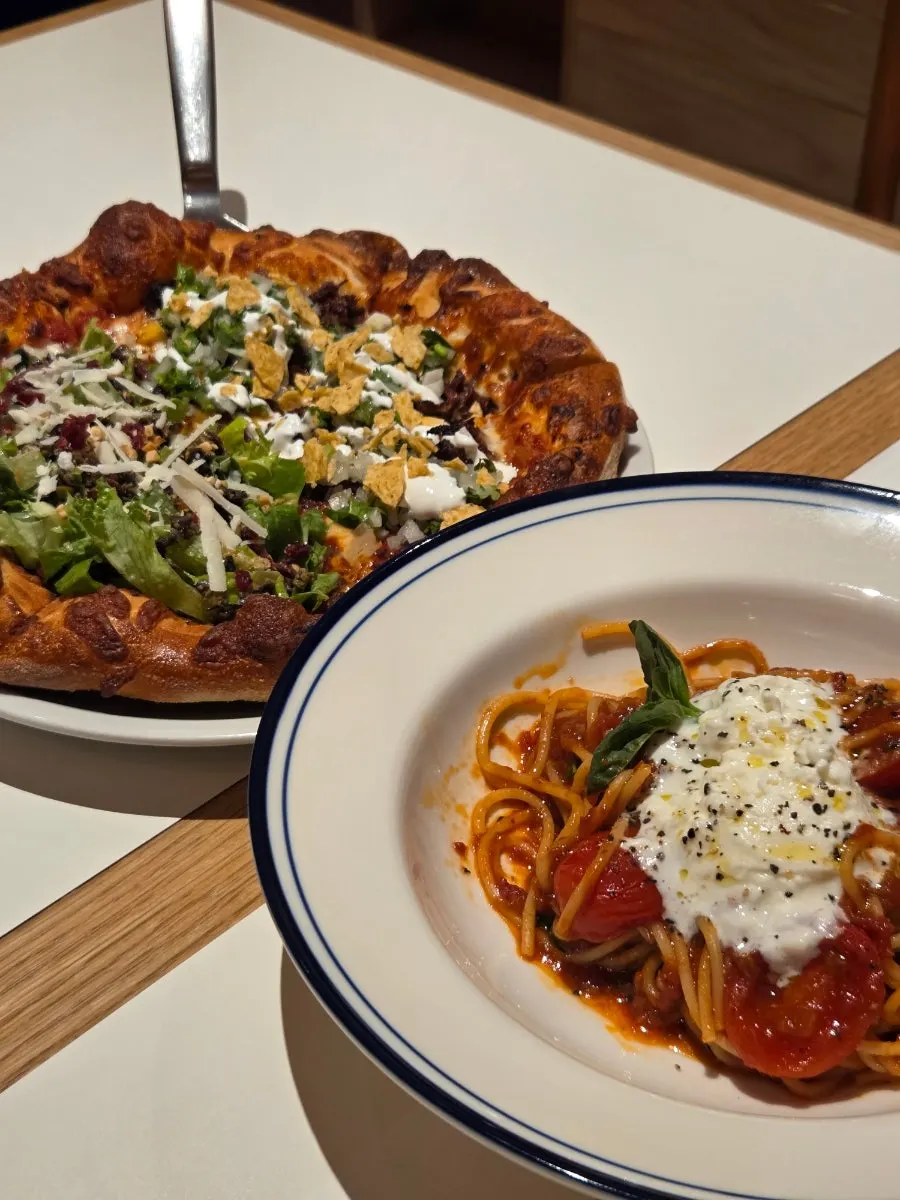 Whole half-and-half Extra Mile pizza on the table