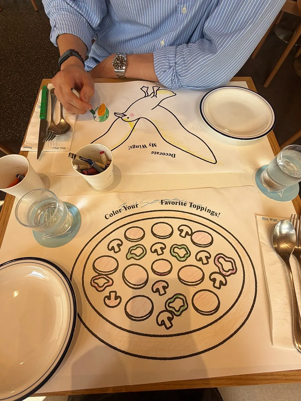 Coloring sheet laid out on an Extra Mile table