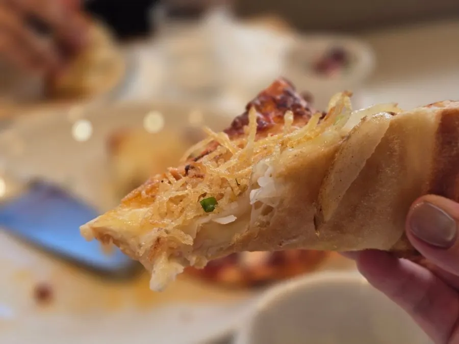 Potato pizza topped with shredded potato
