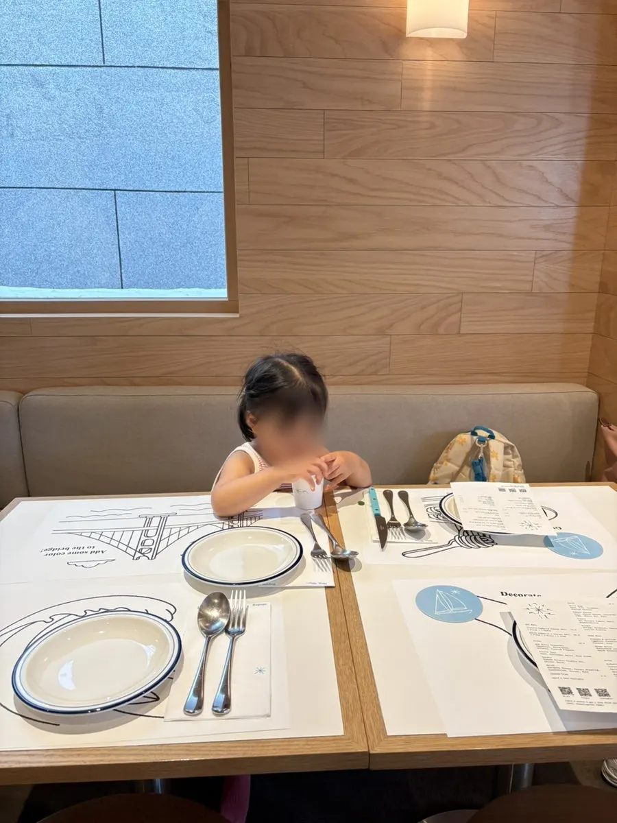 A table at Extra Mile set with coloring supplies for kids