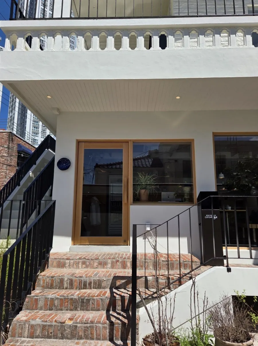 Entrance of Extra Mile with a blue clock