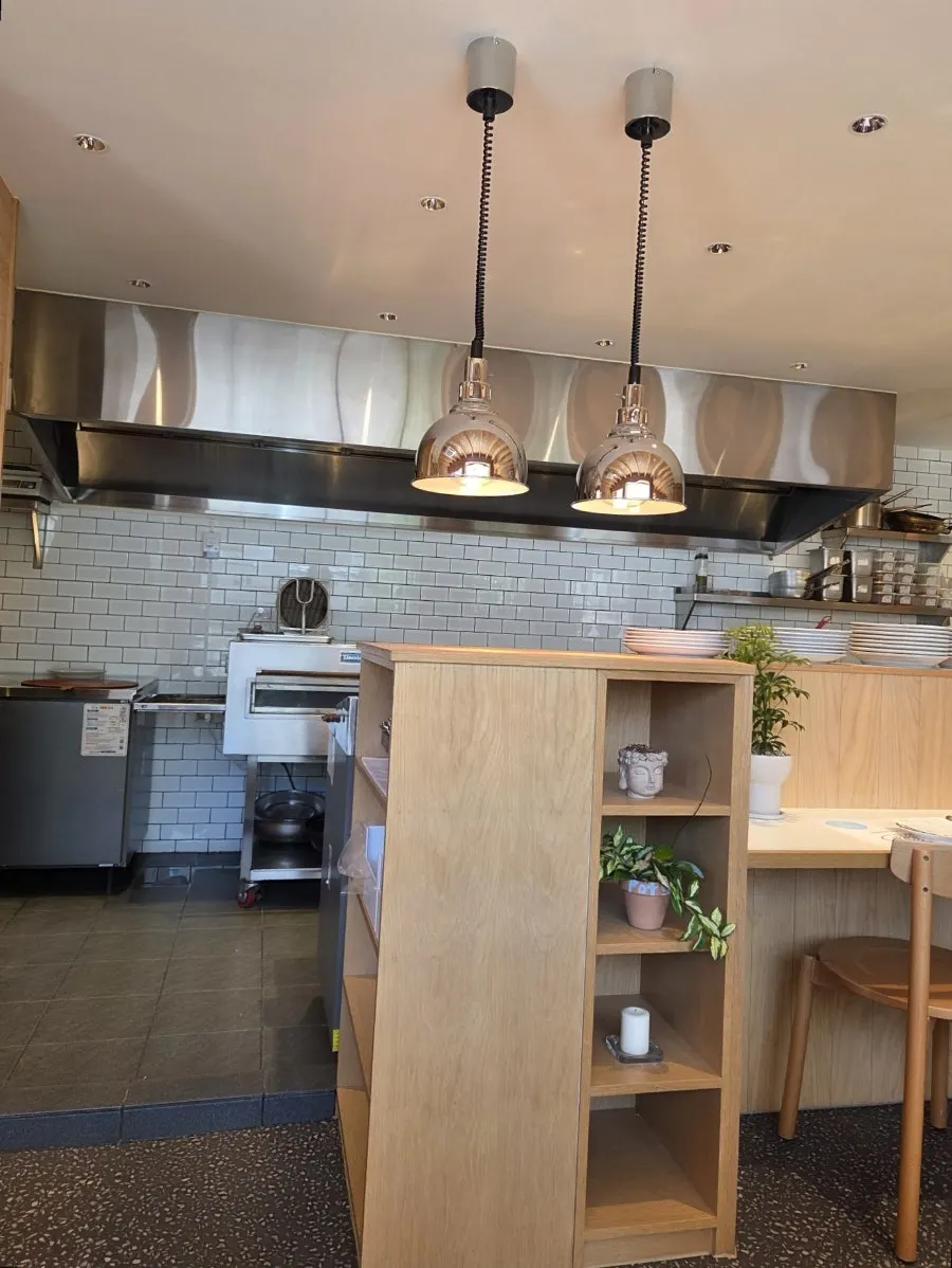 Open kitchen and bar table at Extra Mile
