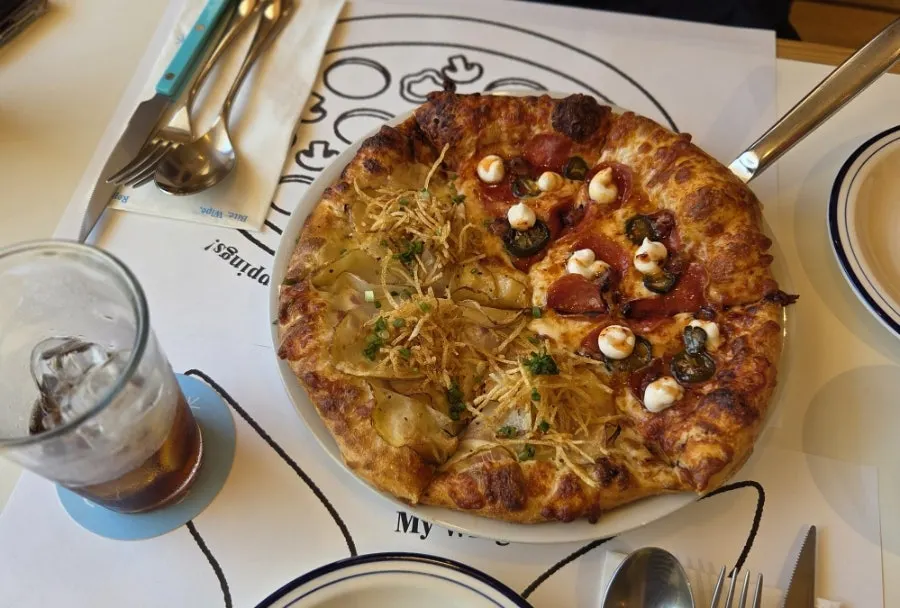 Close-up of a hot honey pepperoni pizza slice