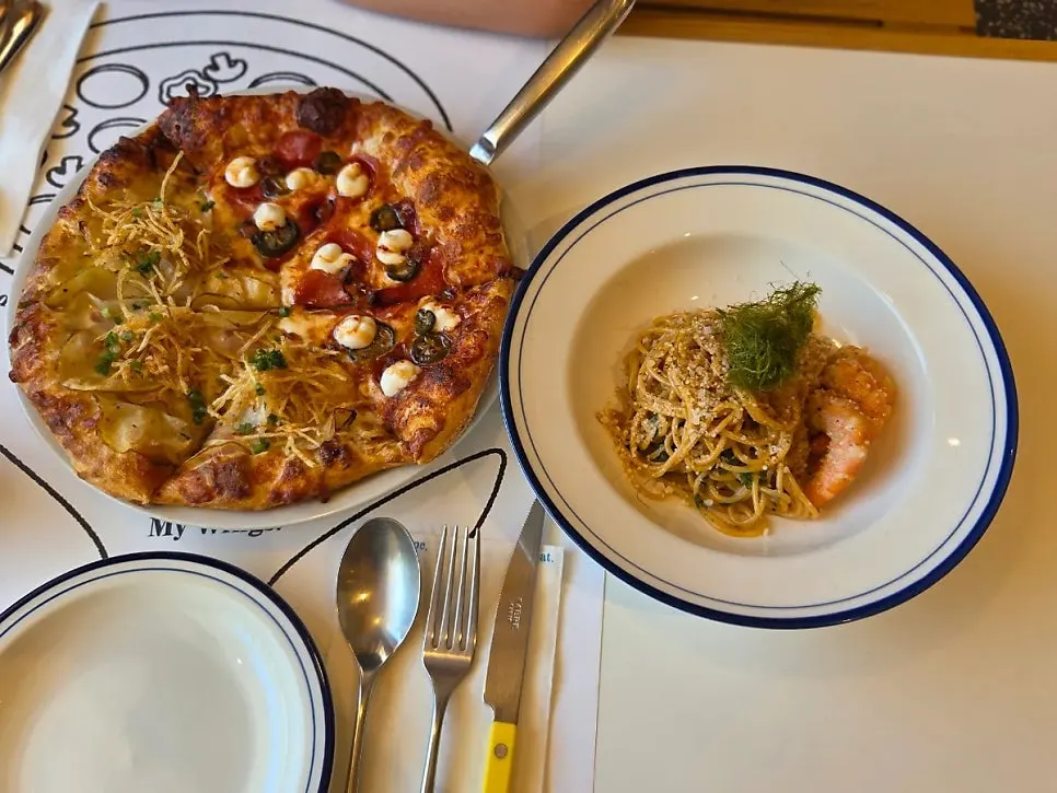 Plate of bisque cream pasta with large shrimp