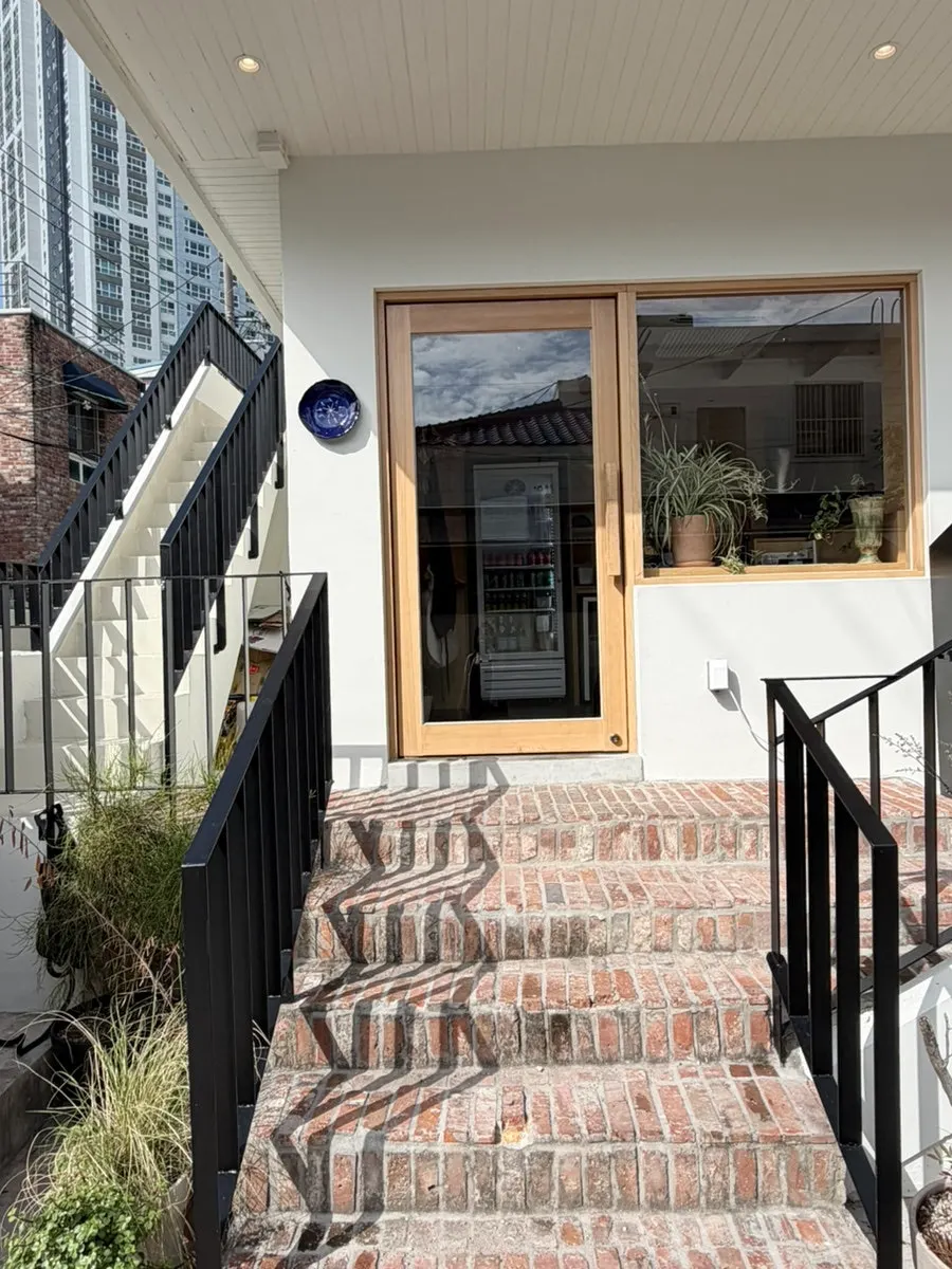 Stairs and exterior decor at Extra Mile's building entrance