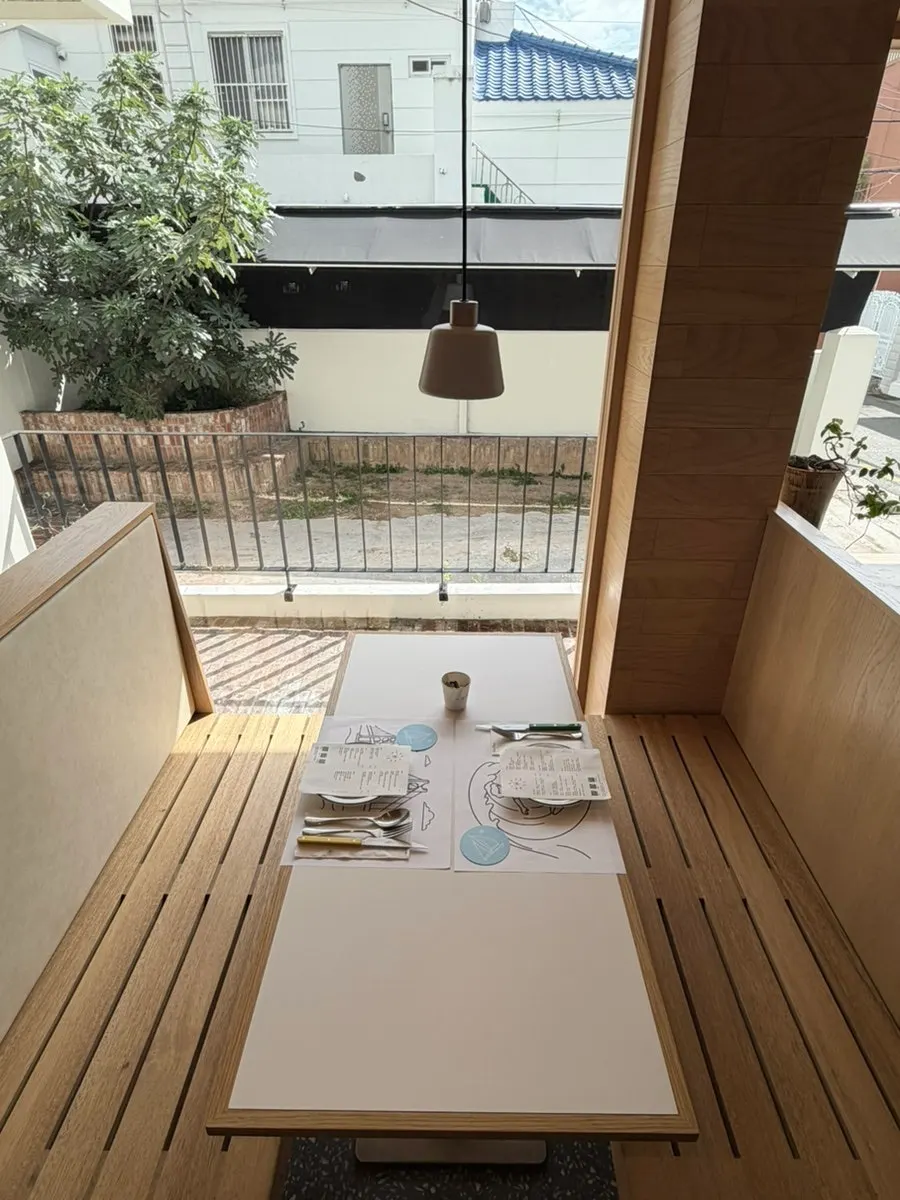 Extra Mile's interior featuring floor-to-ceiling windows and wood tones