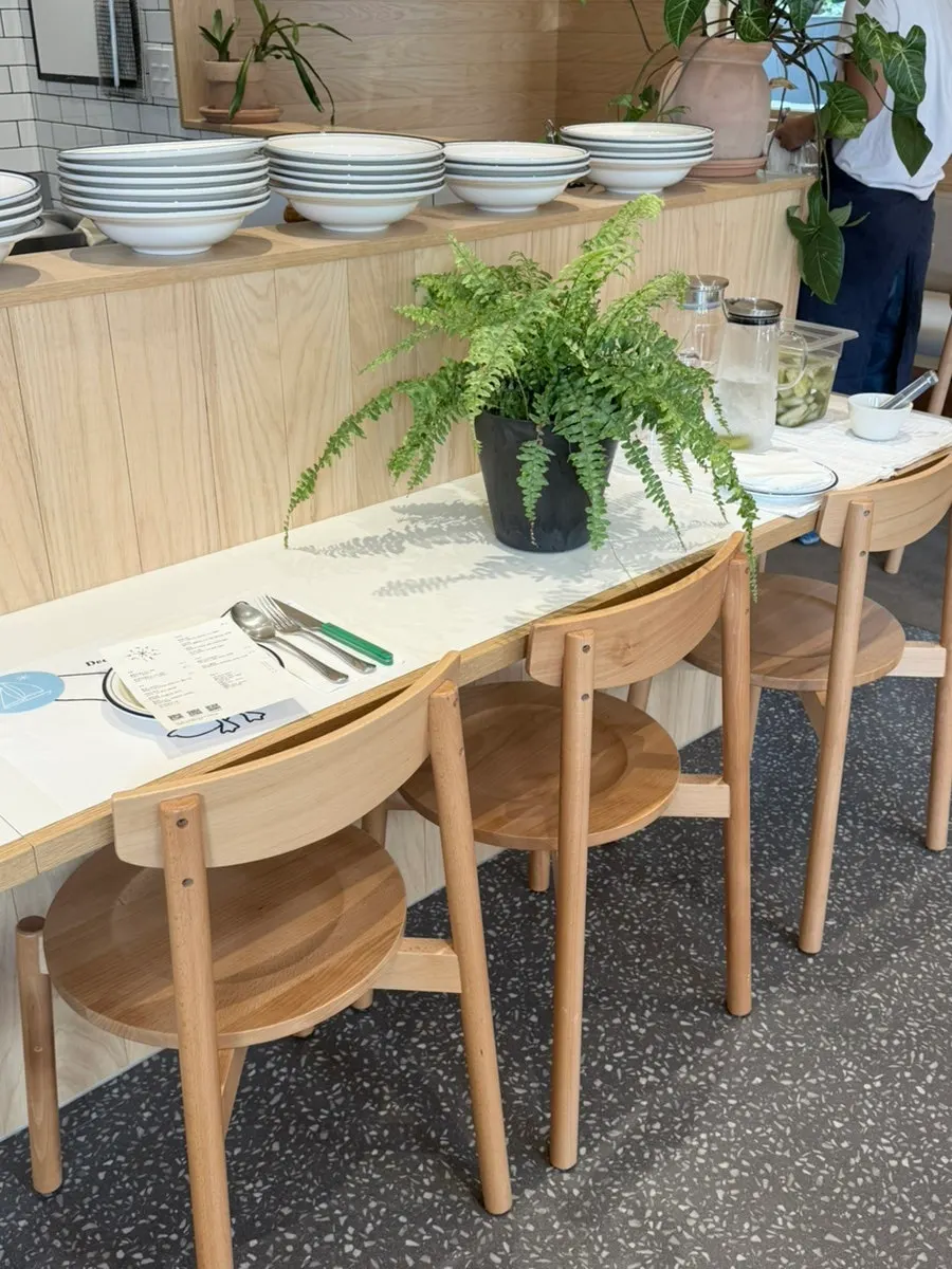 Seating inside Extra Mile with plant pots placed around