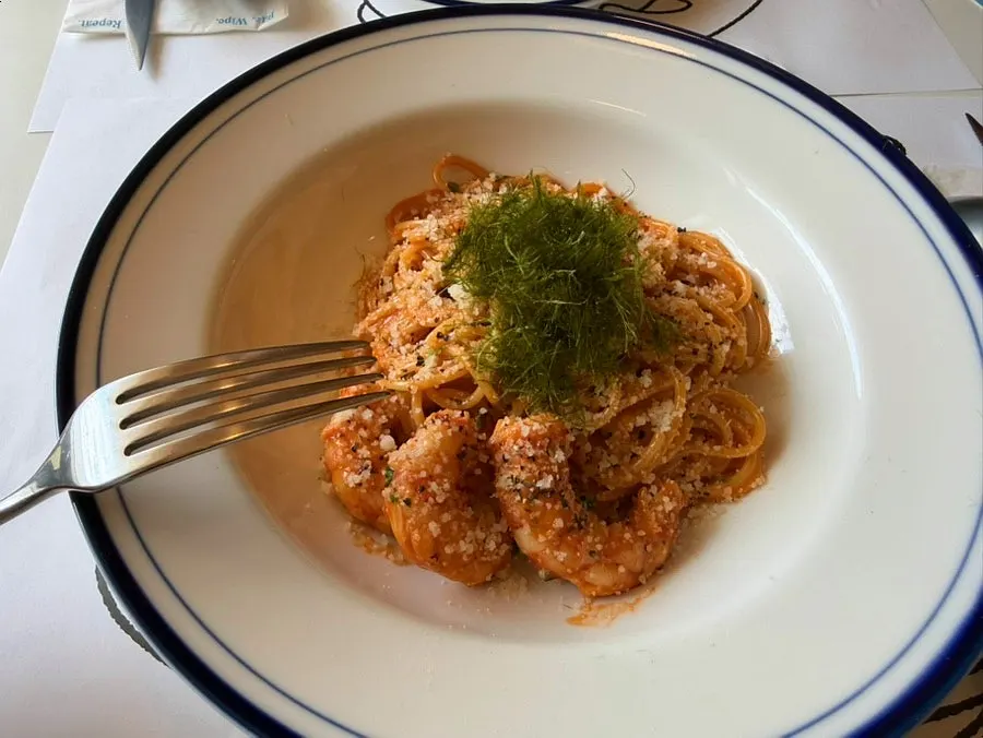 A plate of bisque cream pasta topped with shrimp