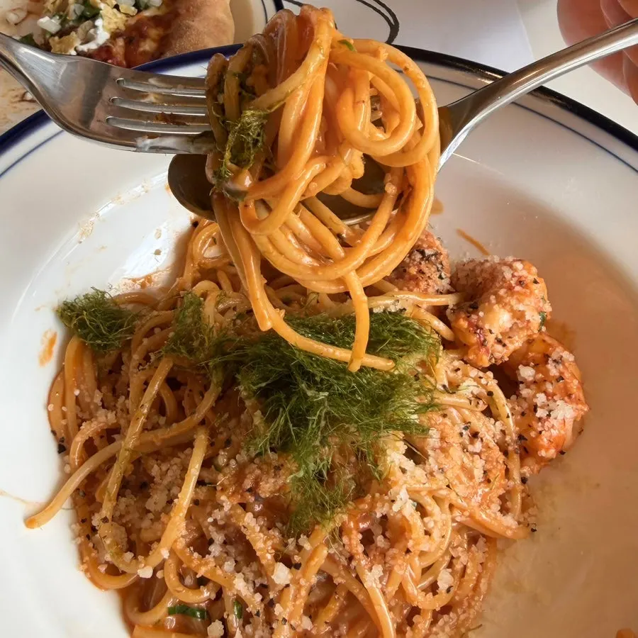 Close-up of bisque cream pasta topped with cheese and gamtae