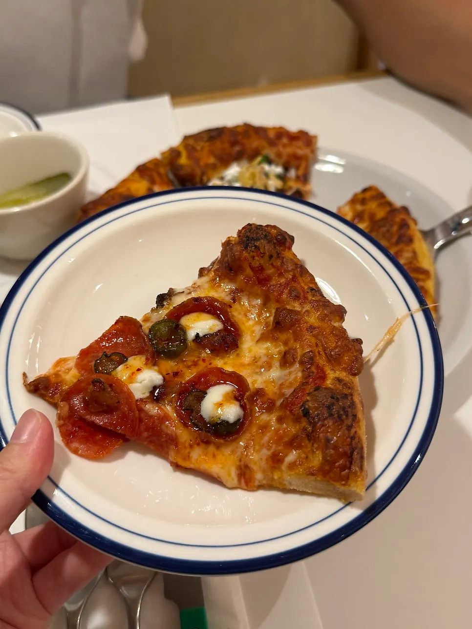Cross-section of pizza topped with pepperoni and cheese