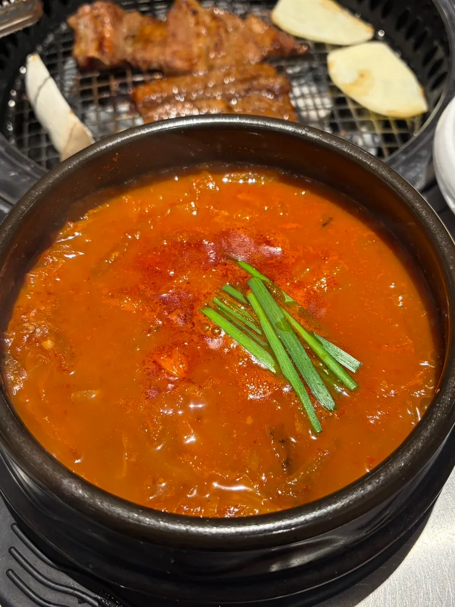 Pot of pork kimchi stew that was ordered alongside the meal
