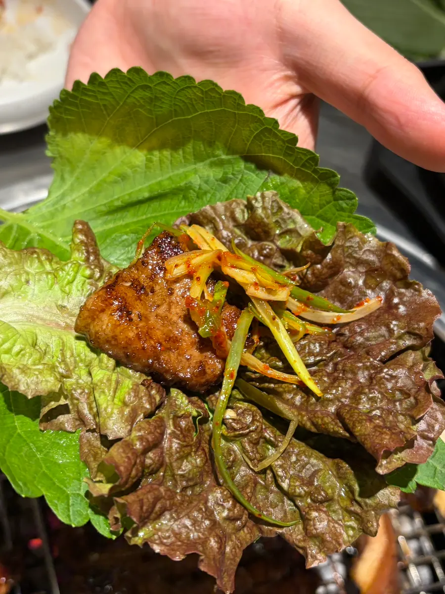 A lettuce wrap piled high with grilled ribs