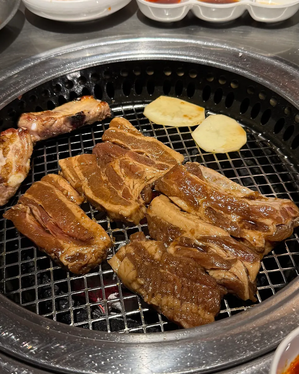 Seasoned ribs placed on a fresh grill plate