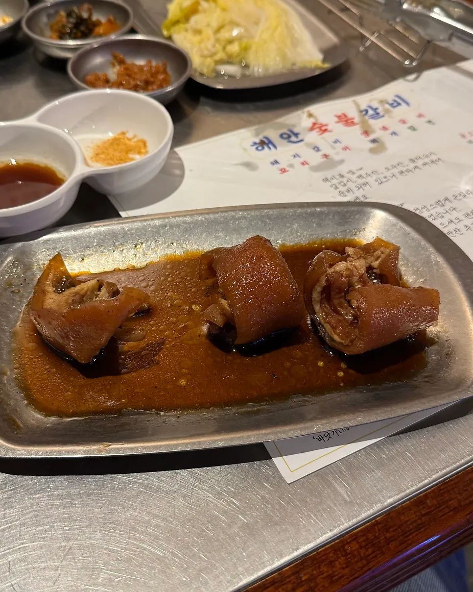 Dark-colored seasoned ribs being grilled